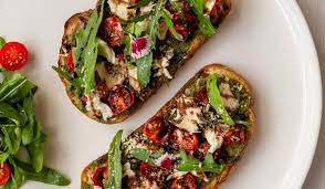 Toasted bread with tomato, herbs and melted cheese